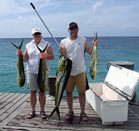 standing on the dock with the catch of the days
