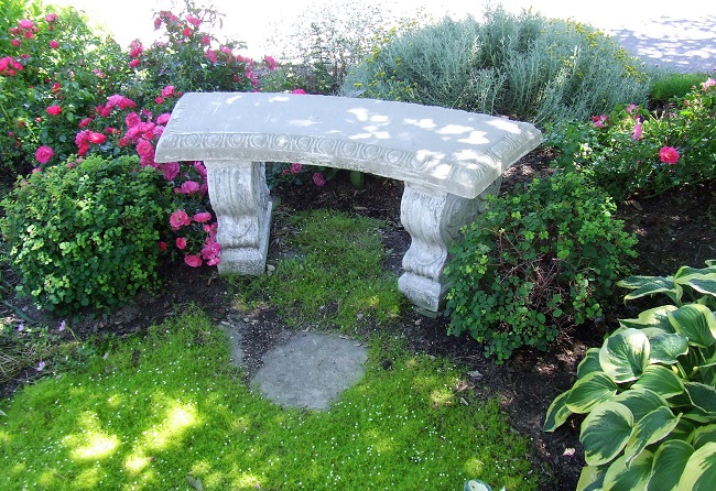 A curved stone bench in a garden